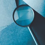 MAGNIFYING GLASS AGAINST BLUE BACKGROUND